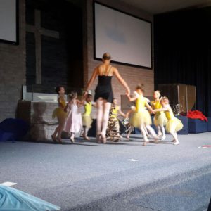 Young ballerinas performing with instructor