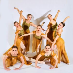 Teenage Ballerinas In Gold Dresses