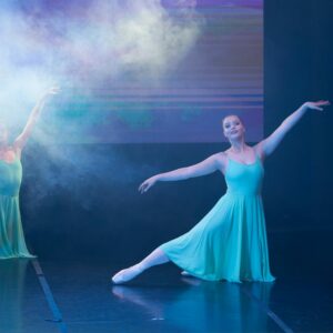 Teenage Ballerinas in Blue Dresses Performing On Stage