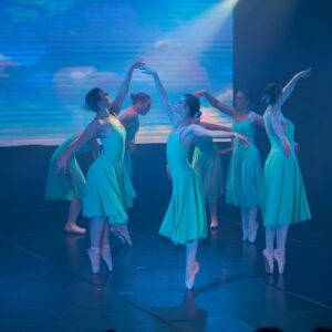 Teenage Ballerinas in Blue Dresses Performing On Stage