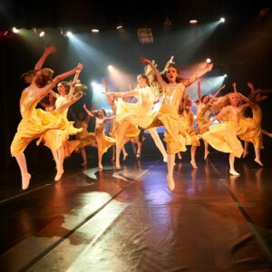 Teenage Ballerinas in Yellow Dresses Performing On Stage