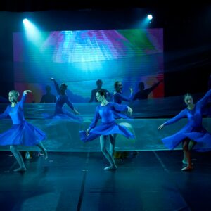 Teenage Ballerinas in Blue Dresses Performing On Stage