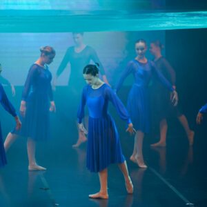 Teenage Ballerinas in Blue Dresses Performing On Stage